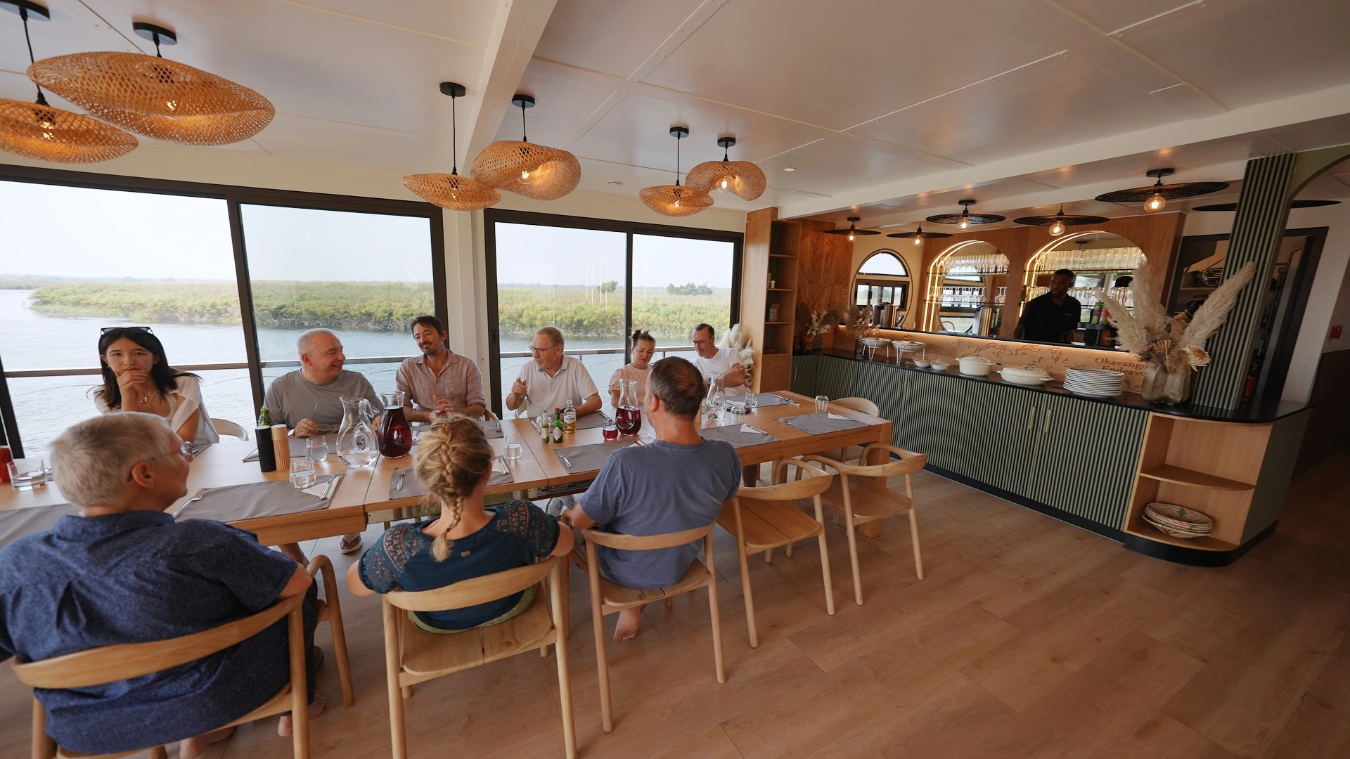 Guests around the dining table aboard the Okavango Endeavour